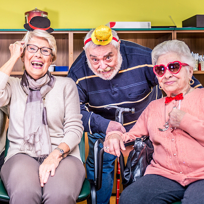Retired Adults wearing gag gifts and laughing